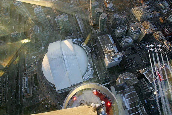 Earlier in the day, from high atop the CN Tower, Ken Lin captures the Snowbirds as Rob Mitchell leads them across the festivities below. Photo Ken Lin