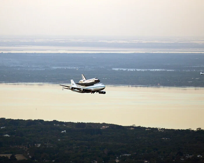 The Shuttle Carrier Aircraft transporting space shuttle Discovery is seen heading south to fly over Brevard County’s beach communities for residents to get a look at the shuttle before it leaves the Space Coast for the last time. Photo credit: (NASA…