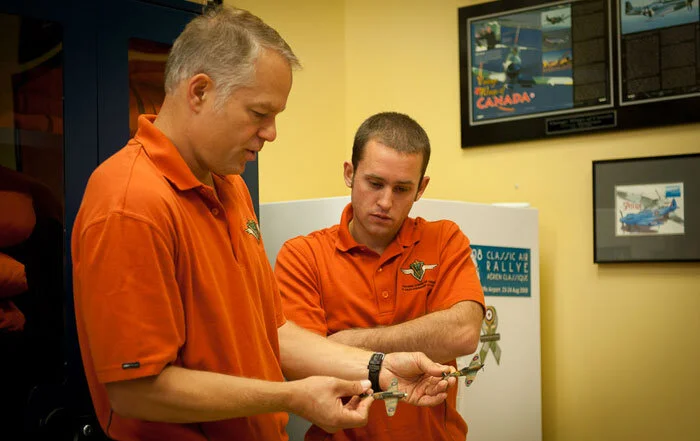 Kissmann tells Doug Fleck, the photoship pilot, what the formation will be doing and how best to position the Van's RV-8 and photographer Handley for top results. Photo: Peter Handley