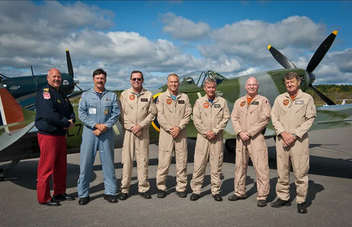 The Vintage Wings Victory Flight balbo pilots pose with Snowbird 1, Team lead Major Chris "Homer" Hope at left. Left to right - Dan Dempsey (Hawk One Sabre); Dave Hadfield (Stocky Edwards P-40 Kittyhawk); Paul Kissmann (Robert Hampton Gray Corsair); Mike Potter (William Harper Spitfire XVI); Rob Erdos (Bunny McLarty Hurricane IV); and, John Aitken (Les Frères Robillard Mustang IV). Photo: Peter Handley
