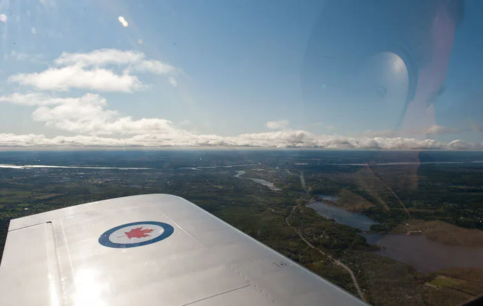 To demonstrate the difficulties for photography through the blown canopy of the RV-8, witness the distorted reflection of pilot Doug Fleck in this shot. Photo: Peter Handley