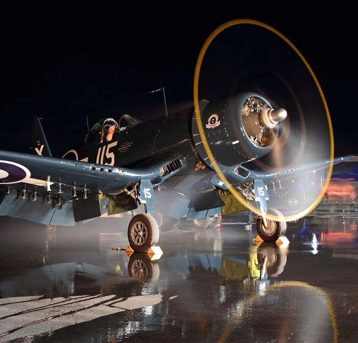With freshly laid water coursing down the barely perceptible slope of the ramp, Paul Kissmann, Chief Pilot of Vintage Wings of Canada, turns over the massively powered Pratt and Whitney Twin Wasp radial with a quickly dissipated cloud of oil smoke. For maximum visual effect, all doors, flaps, and cowls are wide open. One now understands why the night photo shoot excited member photographers so much. The opportunity to see a full prop disc illuminated against the black sky was extremely exciting. Photo: Parr Yonemoto