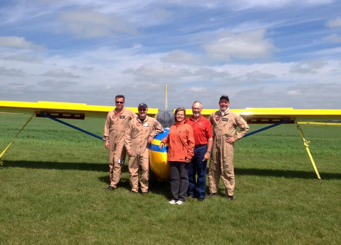 Some of the members of the Yellow Wings Stearman team at Netook, Alberta. Left to right: Todd Lemieux, Yellow Wings Team Lead; Gord Simmons, pilot; Fiona Stevensen; Derek Blatchford, pilot; and Krusti Whelan. There are many folks who make this progr…
