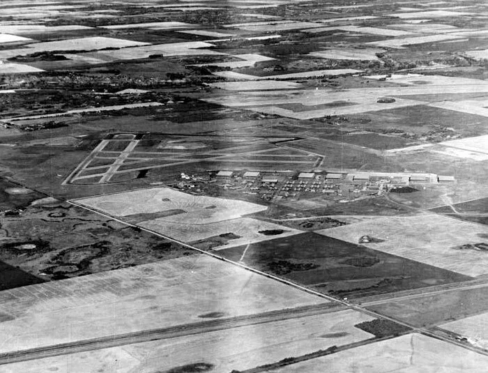 During the Second World War, the small community of Penhold was host to a large and very active base of the British Commonwealth Air Training Plan. In 1940, the base opened as an RCAF Manning Depot with only one building. Five hangars and 31 other buildings (barracks, service and administrative structures) were still under construction well into 1941. Six hard surfaced runways ranging from 900 to 1,075 metres long made up the airfield. Two additional hangars were built for a total of seven. In August 1941, the base was handed over to the RAF and No. 36 Service Flying Training School was transferred from Britain, along with Airspeed Oxford aircraft. Relief fields were set up at Innisfail and Blackfalds.
