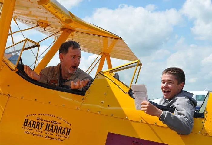 Cadet Taran Nasedkin and pilot Krusti Whelan share a moment of humour as “instructor” 16-year-old Taran jokingly berates his “student” Whelan for not knowing all the items on the Stearman checklist. All the cadets at Penhold were invited to pose for a unique post-flight photograph—and this one takes the cake. Nasedkin is a Sergeant at 577 “Dragonriders” Royal Canadian Air Cadet Squadron in Grande Prairie, Alberta. He was attending the Military Band – Advanced Musician Course at Penhold Cadet Summer Training Centre. Of his flight, Nasedkin said, “I was given the opportunity to participate in the Vintage Wings program and fly a Boeing Stearman, open-cockpit biplane. This was an incredible, once-in-a-lifetime experience. Being able to not only fly in, but to take control of and actually fly the plane was absolutely unreal. There is absolutely nothing like flying in an open-cockpit plane. I’ve flown in gliders and in Cessnas and this is a completely different experience. There are no words that can truly describe it. When I graduate high school, I plan on becoming a Paramedic. I would also like to obtain my private pilot’s licence. I would like to thank the Canadian Cadet Movement, Vintage Wings of Canada, and everyone else who made this incredible experience possible.” Photo: Yellow Wings Stearman Team