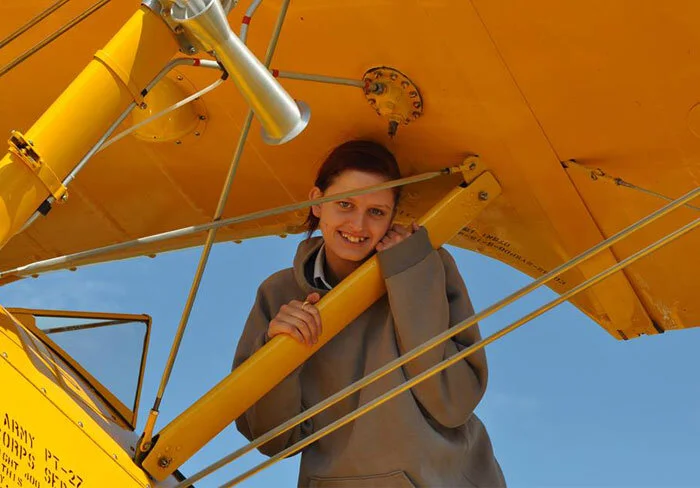 Air cadet Barbara Young, a 17-year-old Flight Sergeant at 107 “Spitfire” Squadron in Saskatoon, Saskatchewan is reluctant to let go of the Stearman after her flight back in time over Penhold. Barbara tells us, “I was super excited when I heard that Vintage Wings was coming to Penhold. This was an amazing experience for me. I have always been interested in aircraft ever since I was little; aircraft and flying have been a passion of mine for a very long time now. I thank Vintage Wings and everyone who have made this opportunity amazing for me. This has honestly been one of the most wonderful experiences of my life... They have inspired me to do what I can do, always keeping your goals high, never doubting yourself and always keeping your head held high. You can only achieve what you put your mind to. I would like to thank Vintage Wings once again for everything and for making one of my dreams come true.” Photo: Yellow Wings Stearman Team