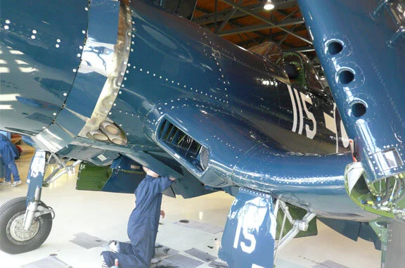 Volunteers surround the oil bleeding Corsair every time she lands to make sure no dirt and oil accumulate - every Saturday it seems, there are several enthusiastic volunteers wiping her down like a thoroughbred racehorse after a race.  Photo: D…