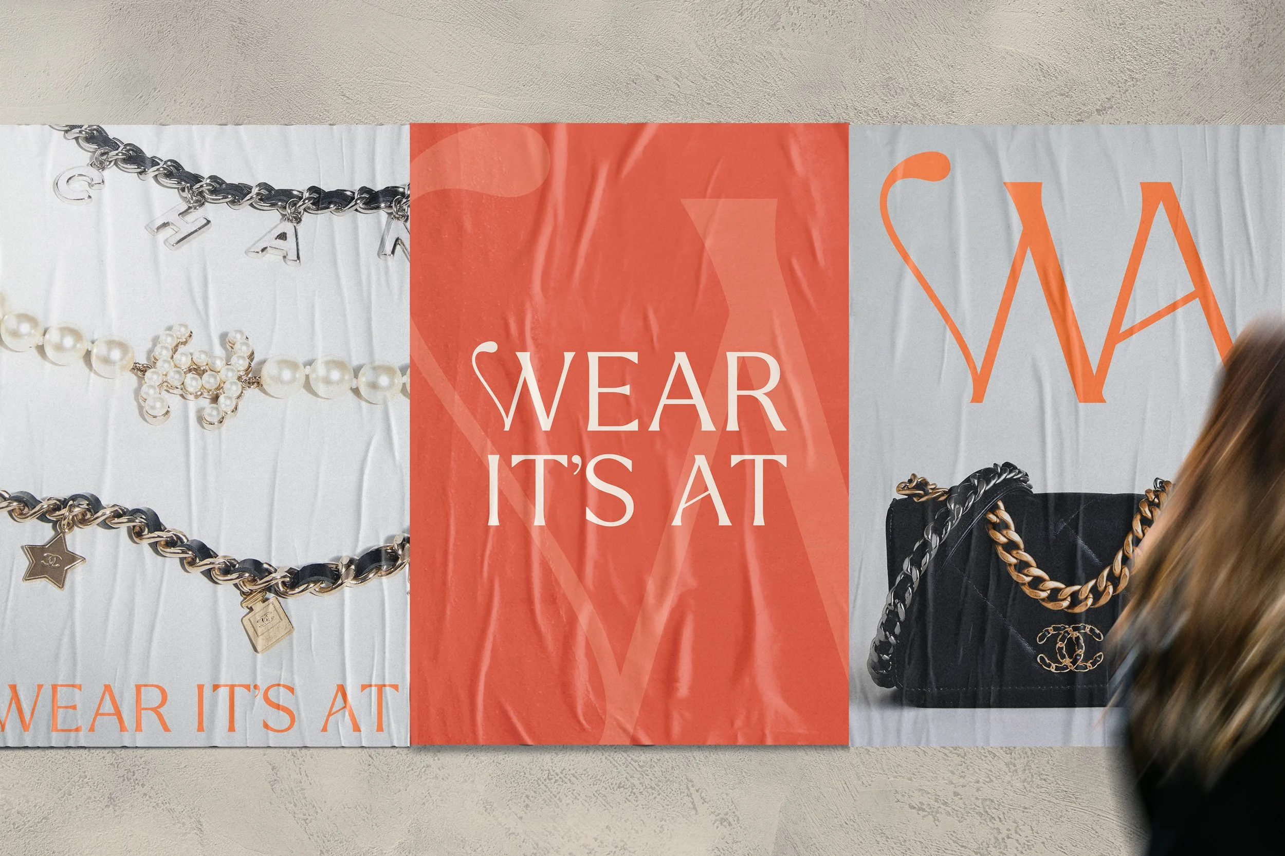 Promotional poster featuring jewelry and accessories, with the text 'WEAR IT'S AT' displayed in the center.