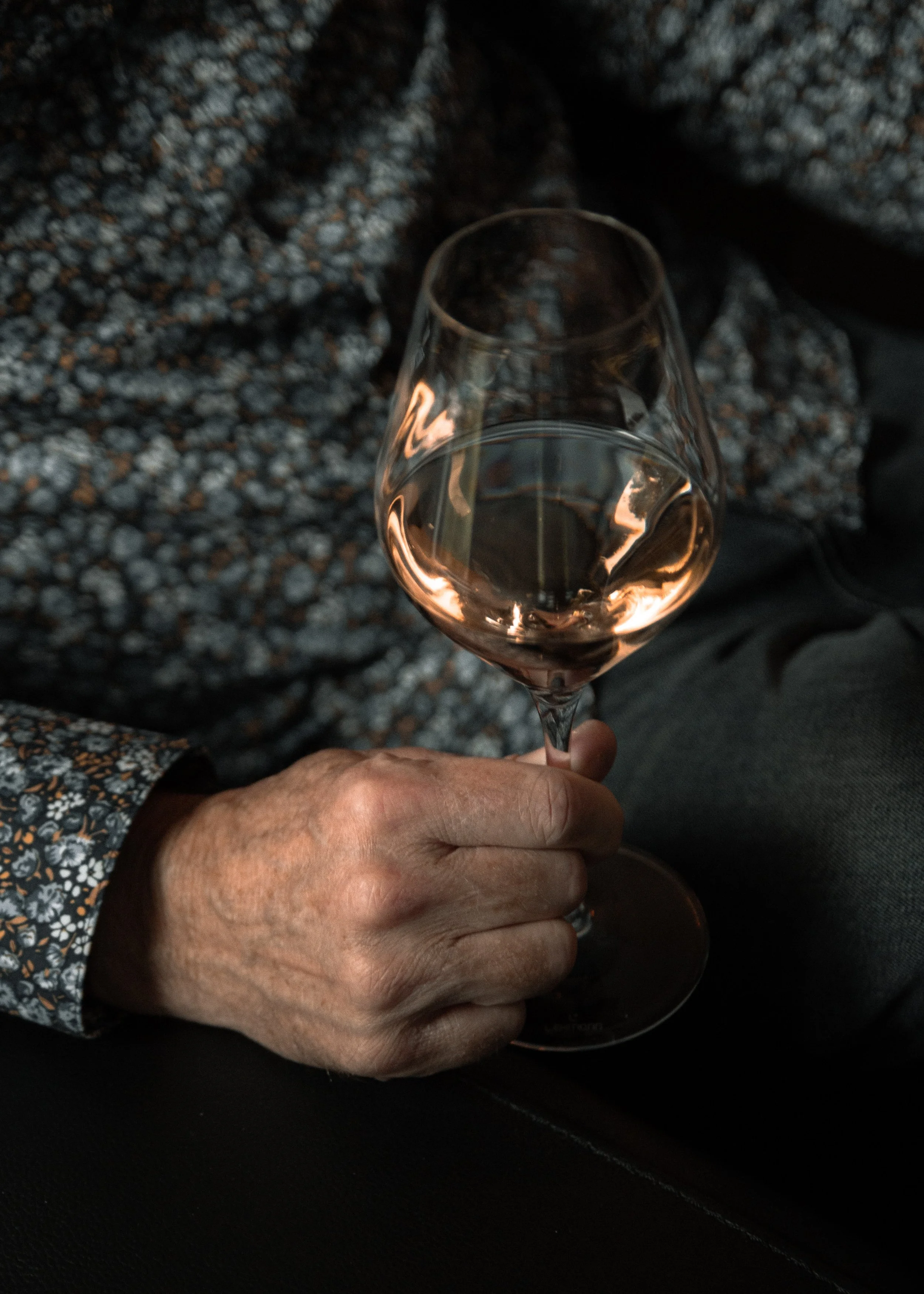 Man holding a glass of rosé