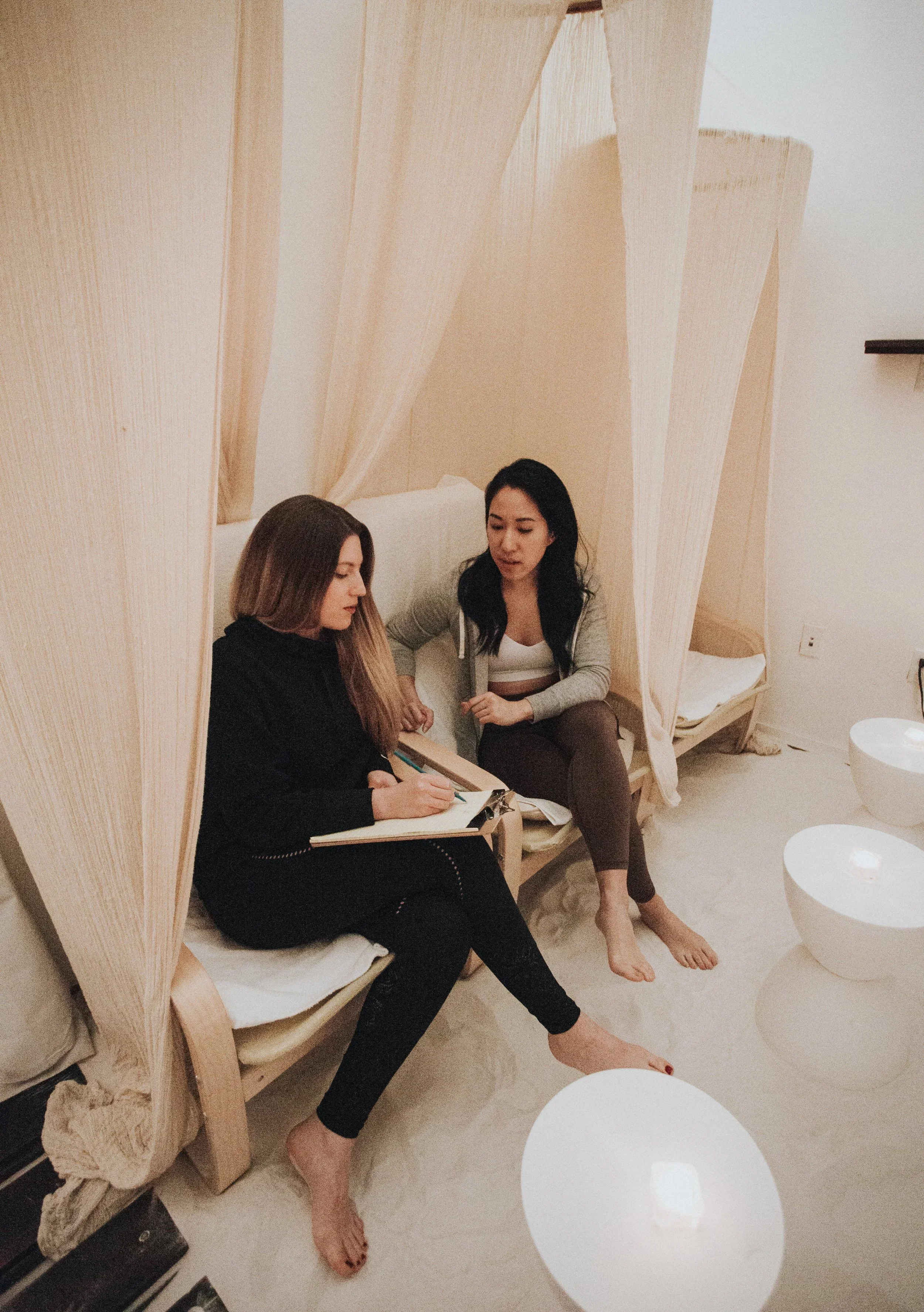 Wellness coaching session at City Sweats with a coach guiding a client through personalized health and recovery planning.