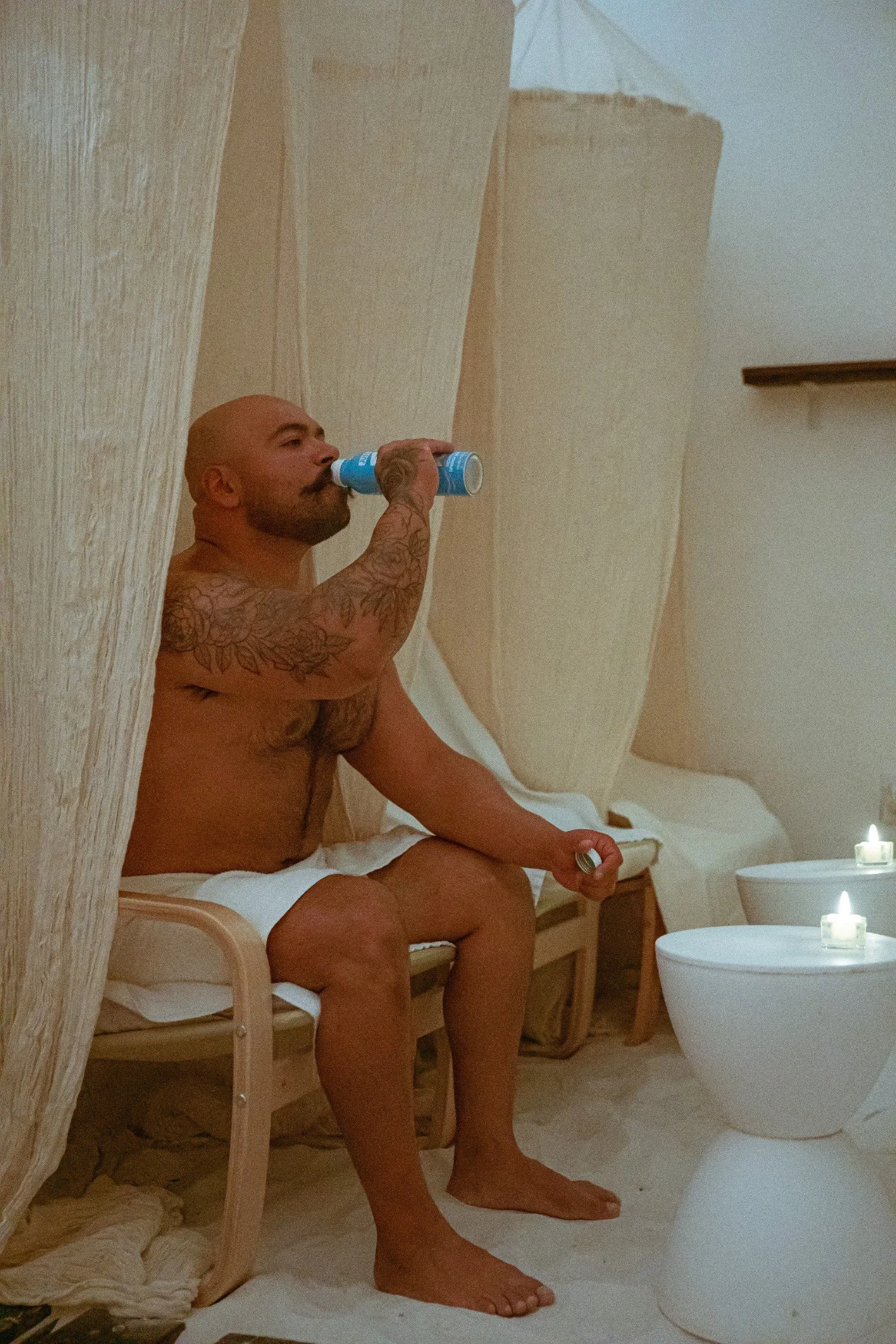 Man resting and hydrating in a calm wellness space at City Sweats, highlighting recovery focused wellness franchise opportunities in Alaska.