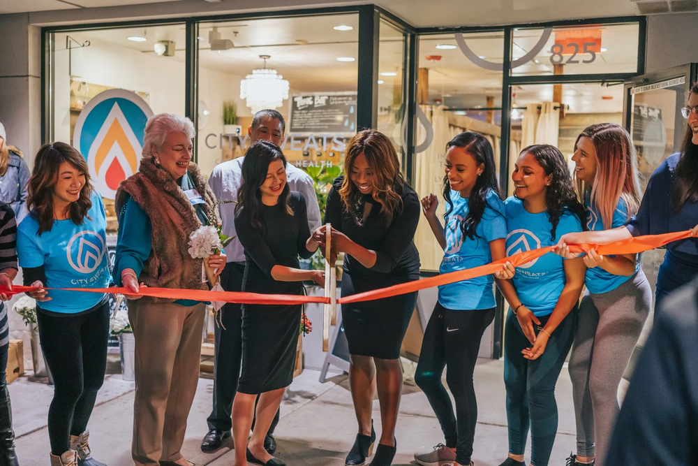 City Sweats team and community members celebrating a wellness studio grand opening, representing a proven and growing wellness franchise opportunity in Alaska.