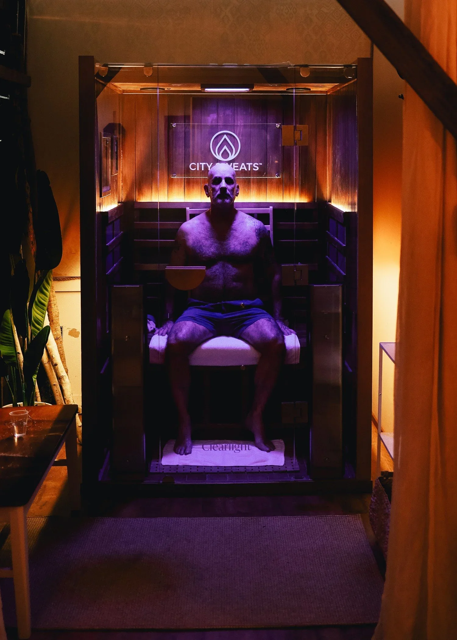 Man sitting in a private infrared sauna at City Sweats, highlighting a premium wellness franchise opportunity in Alaska.