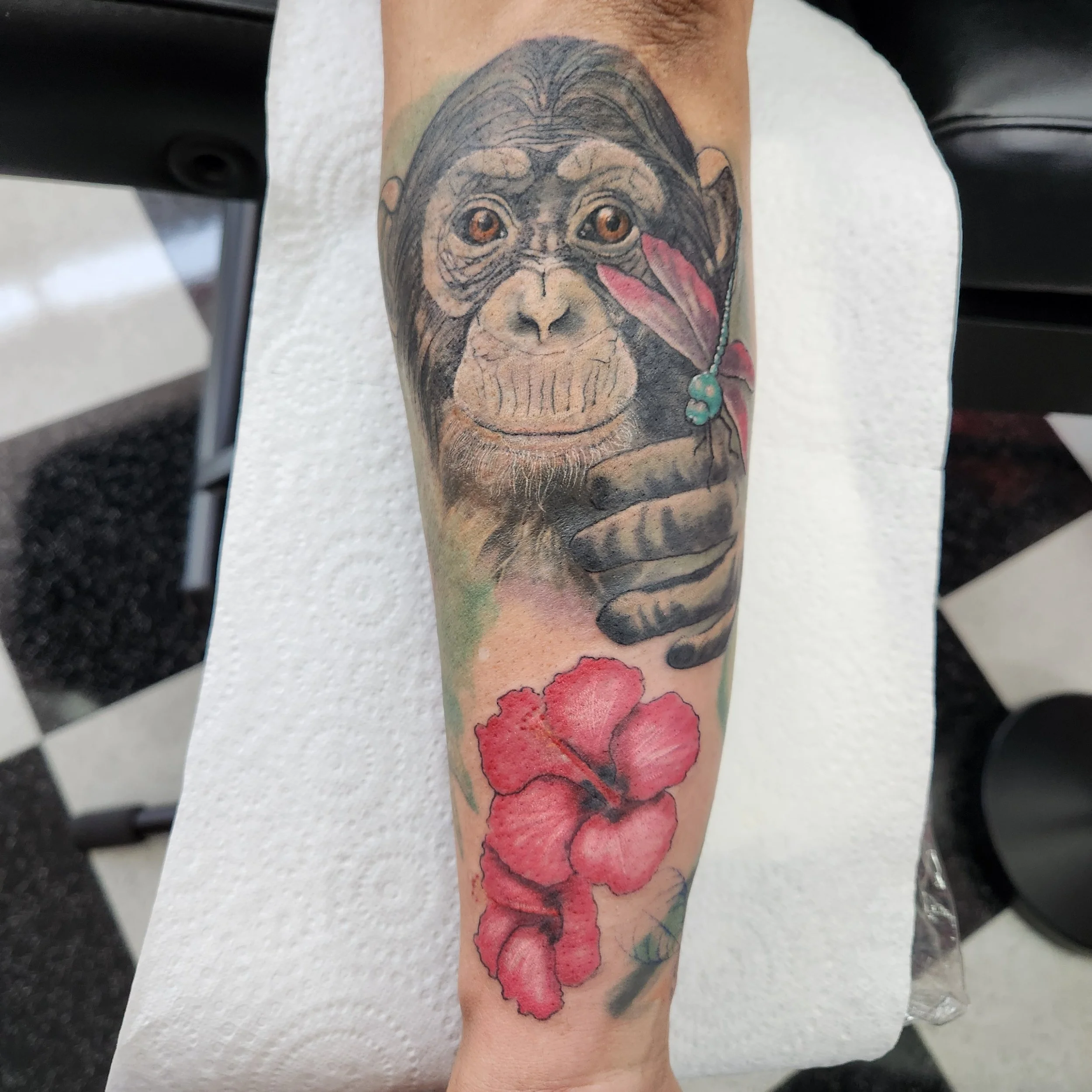 This was a rework of an existing tattoo, which had lost definition over time, so I added a fresh chimp, more colour, and floral