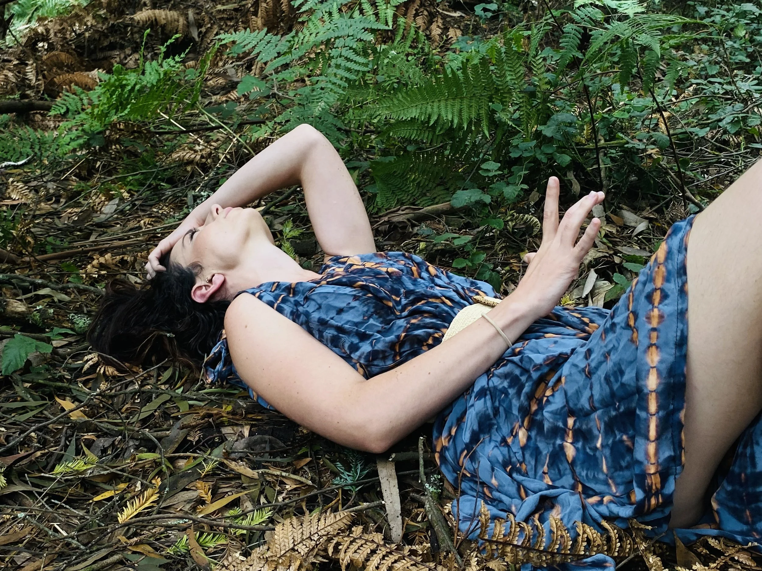 Embodied woman in a moment of stillness, representing contraction and expansion in the healing journey