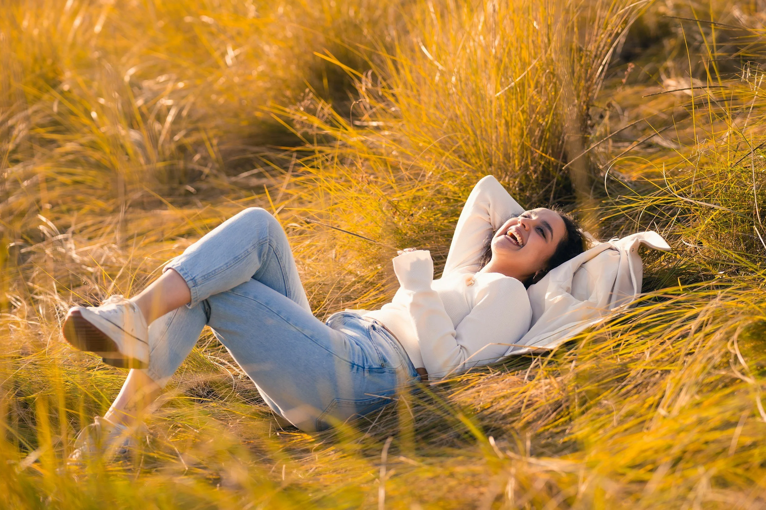 woman lying relaxed with eyes closed representing nervous system regulation and inner calm