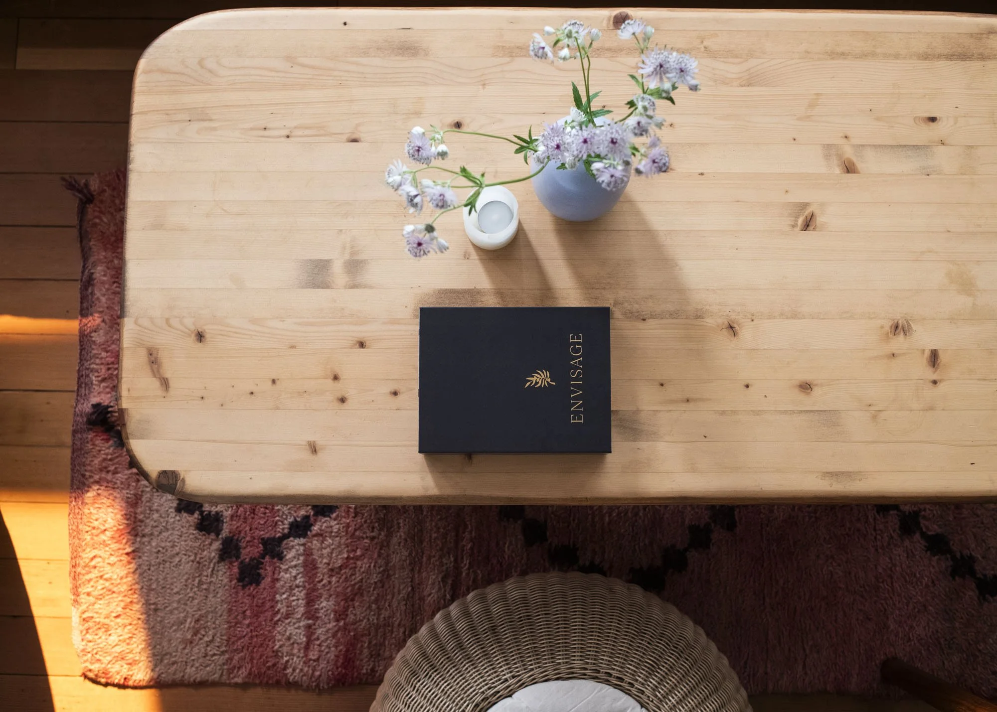 ENVISAGE deck placed on a coffee table with flowers a candle