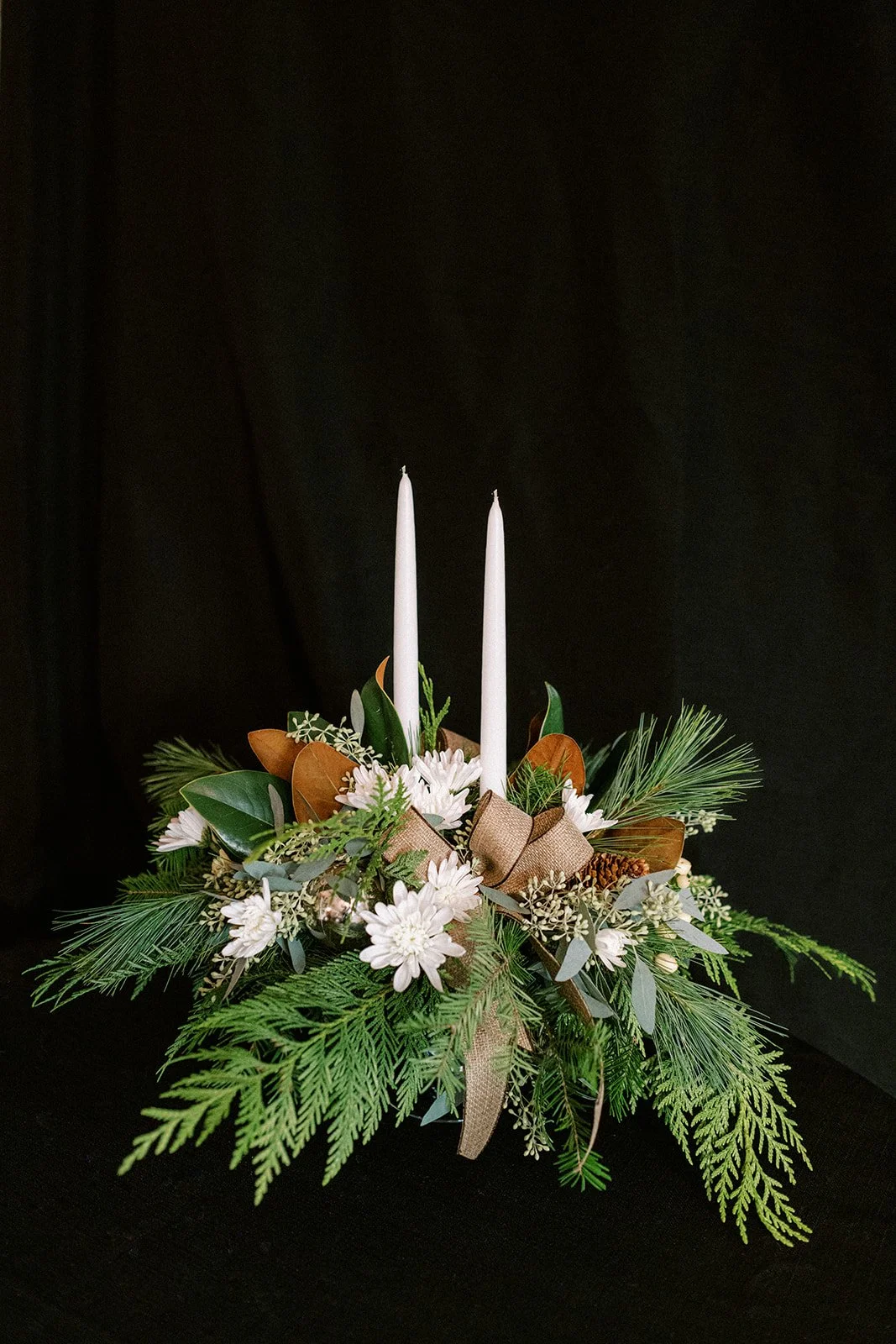 traditional holiday centerpiece with taper candles, whites