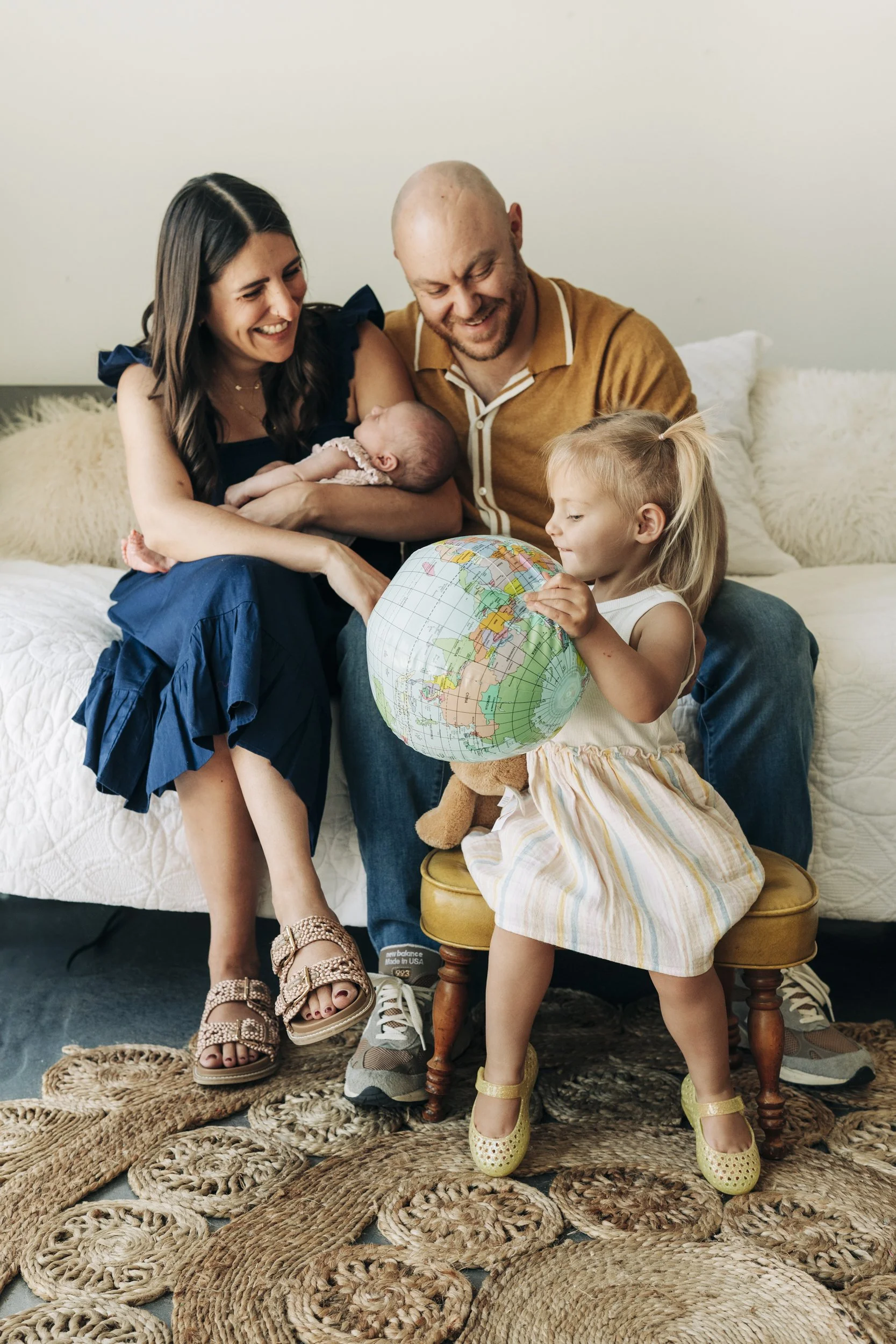 Family in a photo session in a studio in S. Denver. Mom, dad, baby and big sister.