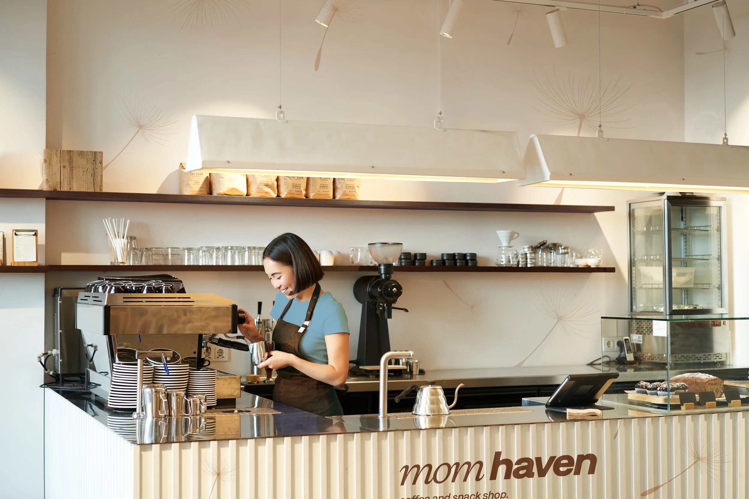 portrait-cafe-counter-with-barista-girl-working-with-coffee-machine-making-order-client-sh copy.jpg