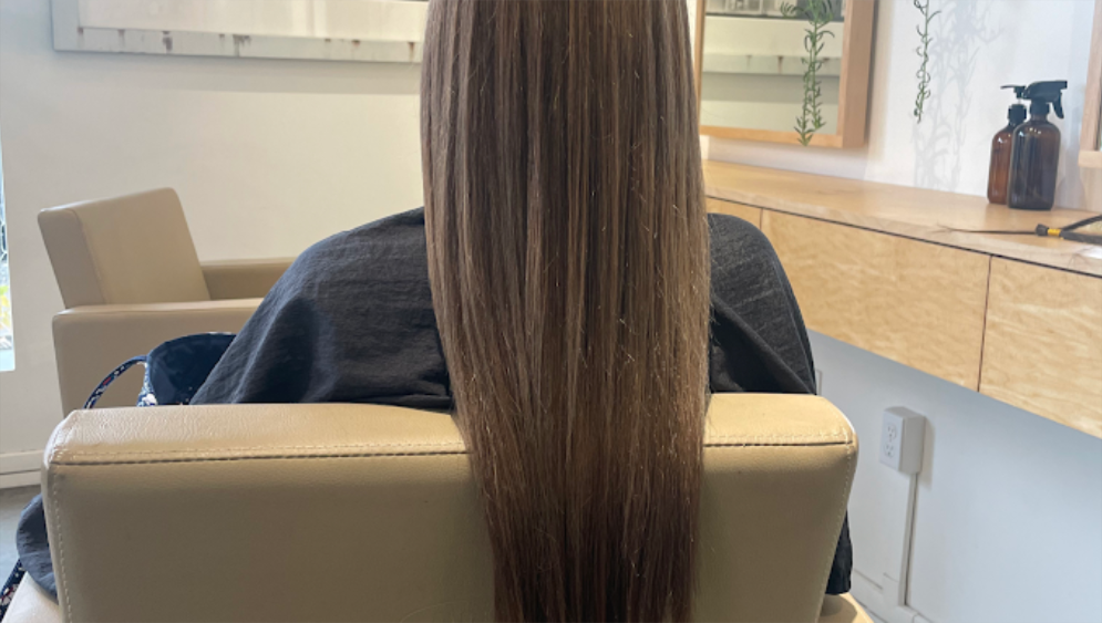 Hair extensions in Portland by Portland Hair Extensions by Penelope showcasing long, smooth, natural-looking brunette hair.