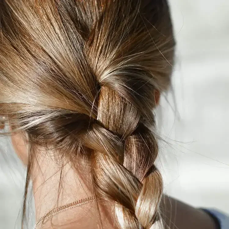 Beautiful long braided hairstyle after professional hair extensions in Portland Oregon by Penelope Hair Salon