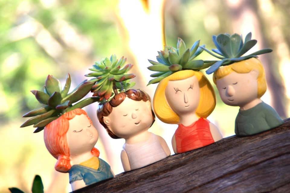 A set of 4 Girl Planters