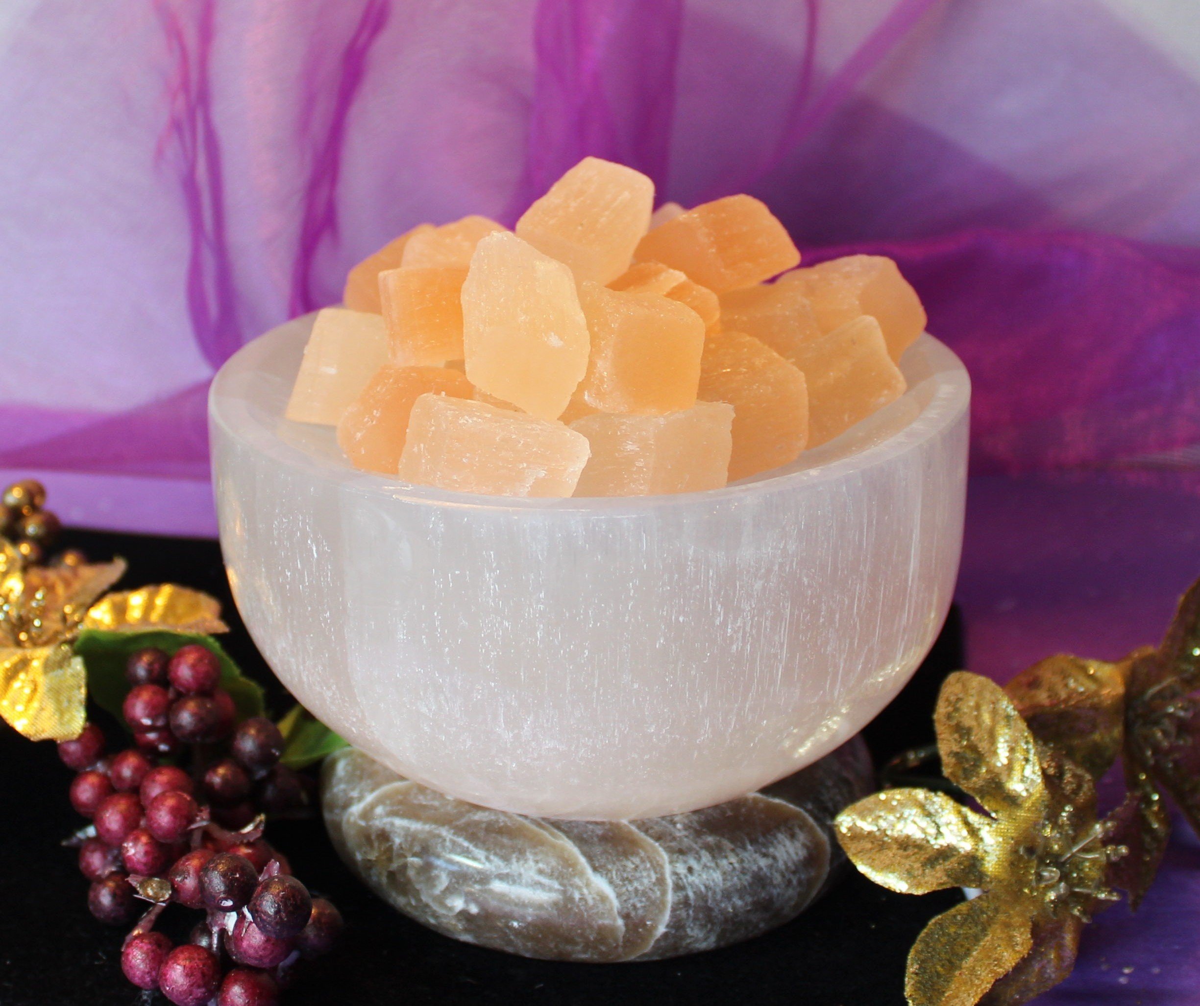 Ethereal White Selenite Bowl with peach selenite cubes on an onyx base. Illuminates your space with a soft, angelic glow, enhancing spiritual ambiance and tranquility