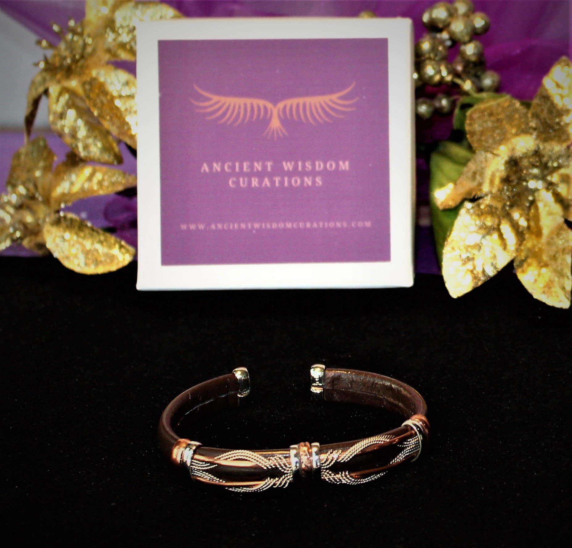 Artisan-made brown leather cuff bracelet featuring an intricate, twisted design with different colored coppers—elegant and durable, perfect for any occasion.