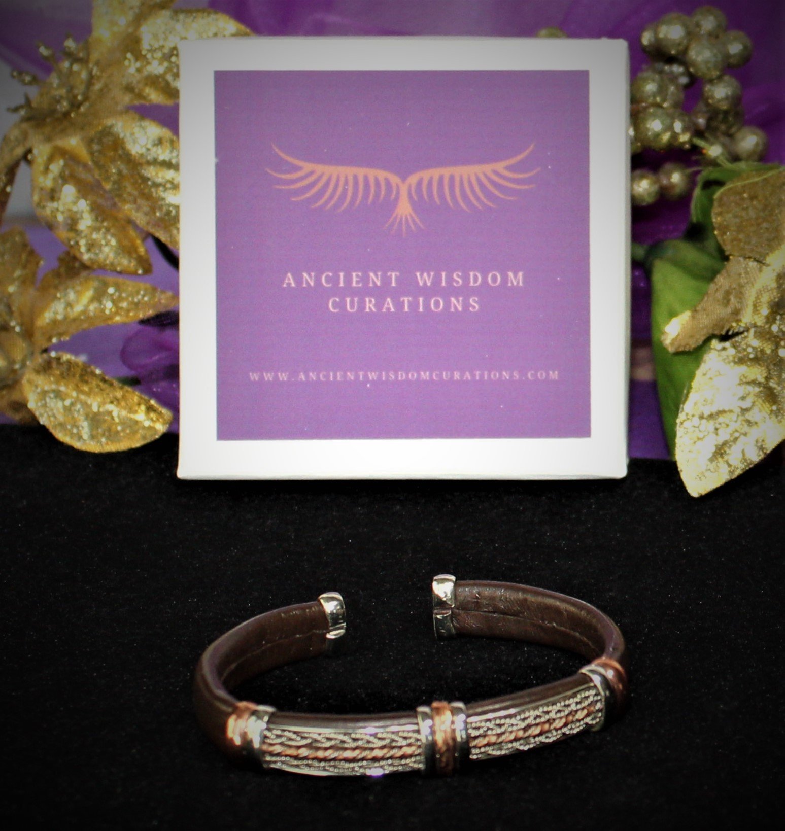 Artisan-made brown leather cuff bracelet featuring a detailed braided design with varied colored coppers—elegant and durable, perfect for any occasion.