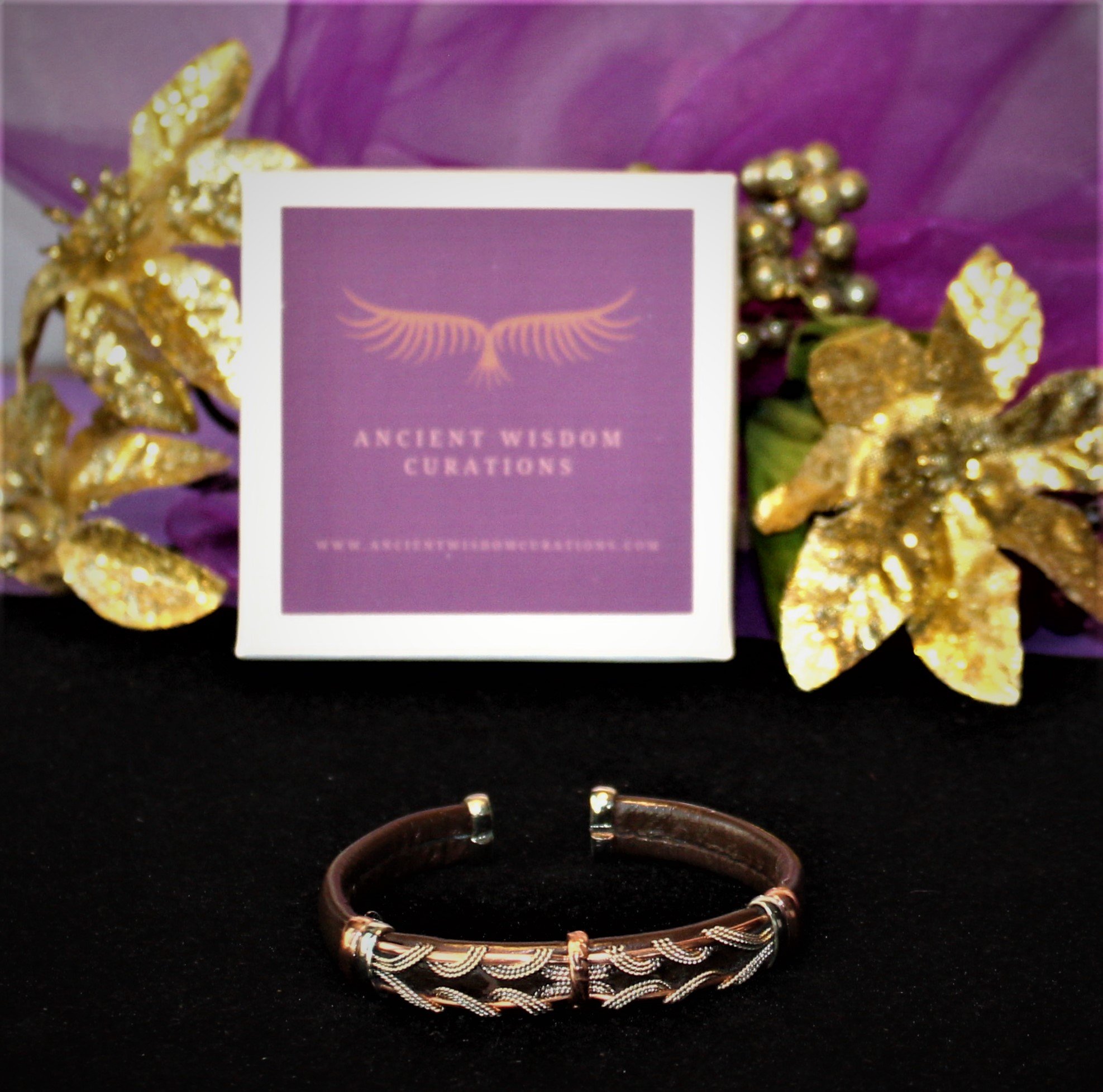 Artisan-made brown leather cuff bracelet featuring a wave-like pattern with varied colored coppers—elegant and durable, perfect for any occasion.
