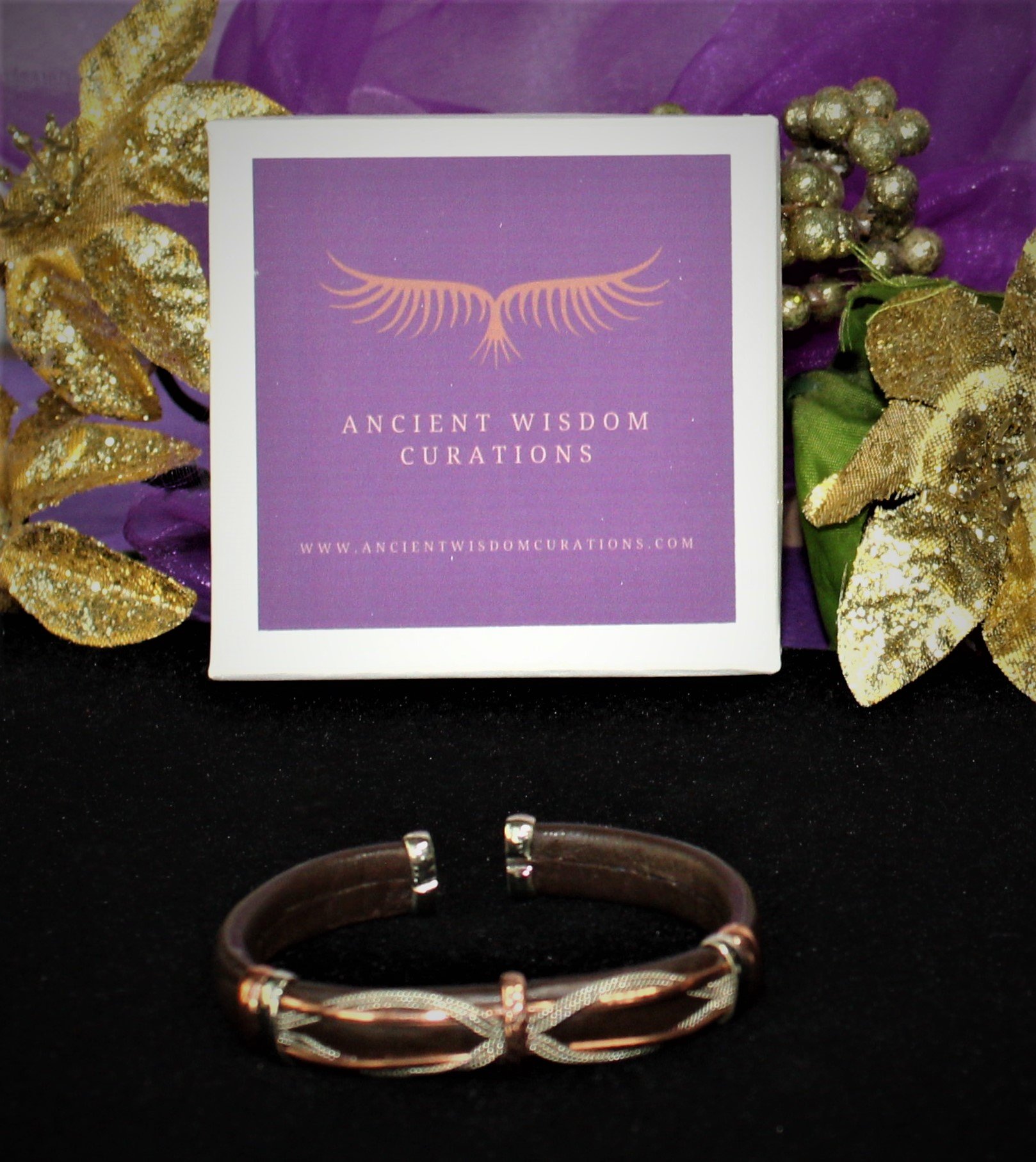 Artisan-made brown leather cuff bracelet featuring an intertwined loop design with varied colored coppers—elegant and durable, perfect for any occasion.