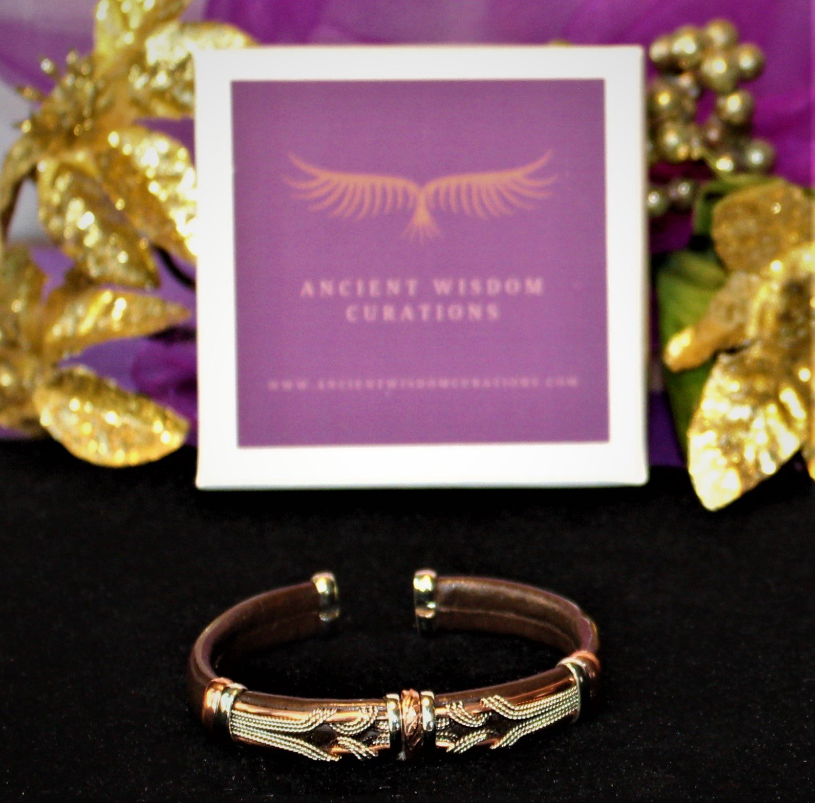 Artisan-made brown leather cuff bracelet featuring a flowing wave pattern with varied colored coppers—elegant and durable, perfect for any occasion.