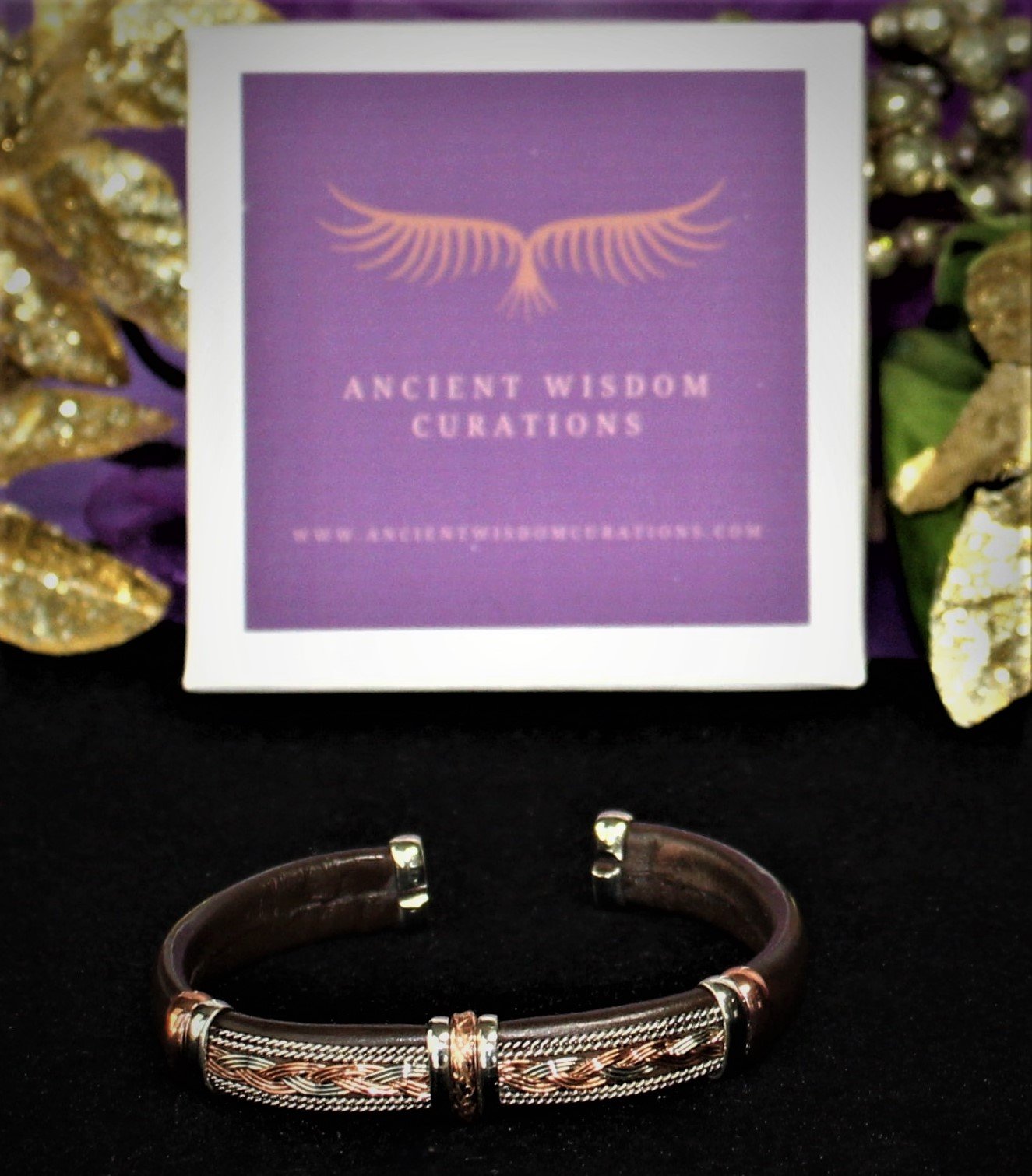 Artisan-made brown leather cuff bracelet featuring a braided and textured pattern with varied colored coppers—elegant and durable, perfect for any occasion.