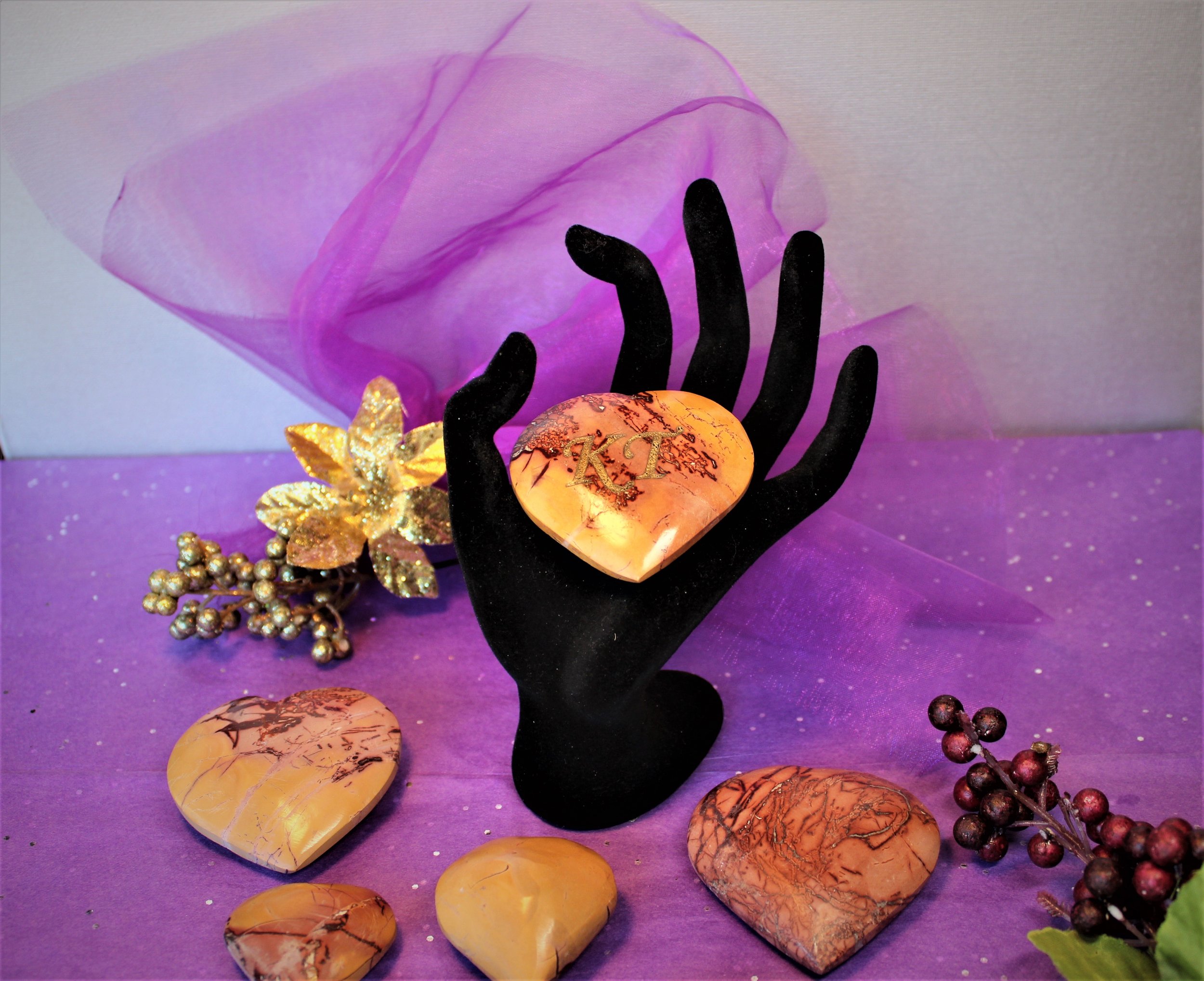 Engraved Mookaite stone hearts with intricate natural patterns, symbolizing ancient wisdom for modern living—perfect for mindful decor or a meaningful gift.