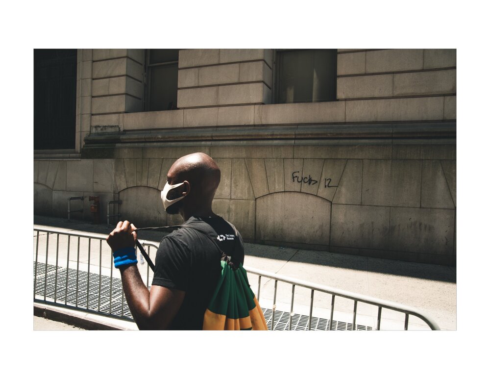  A person walks by Graffiti painted on the side of the Surrogates Court building in Manhattan. 