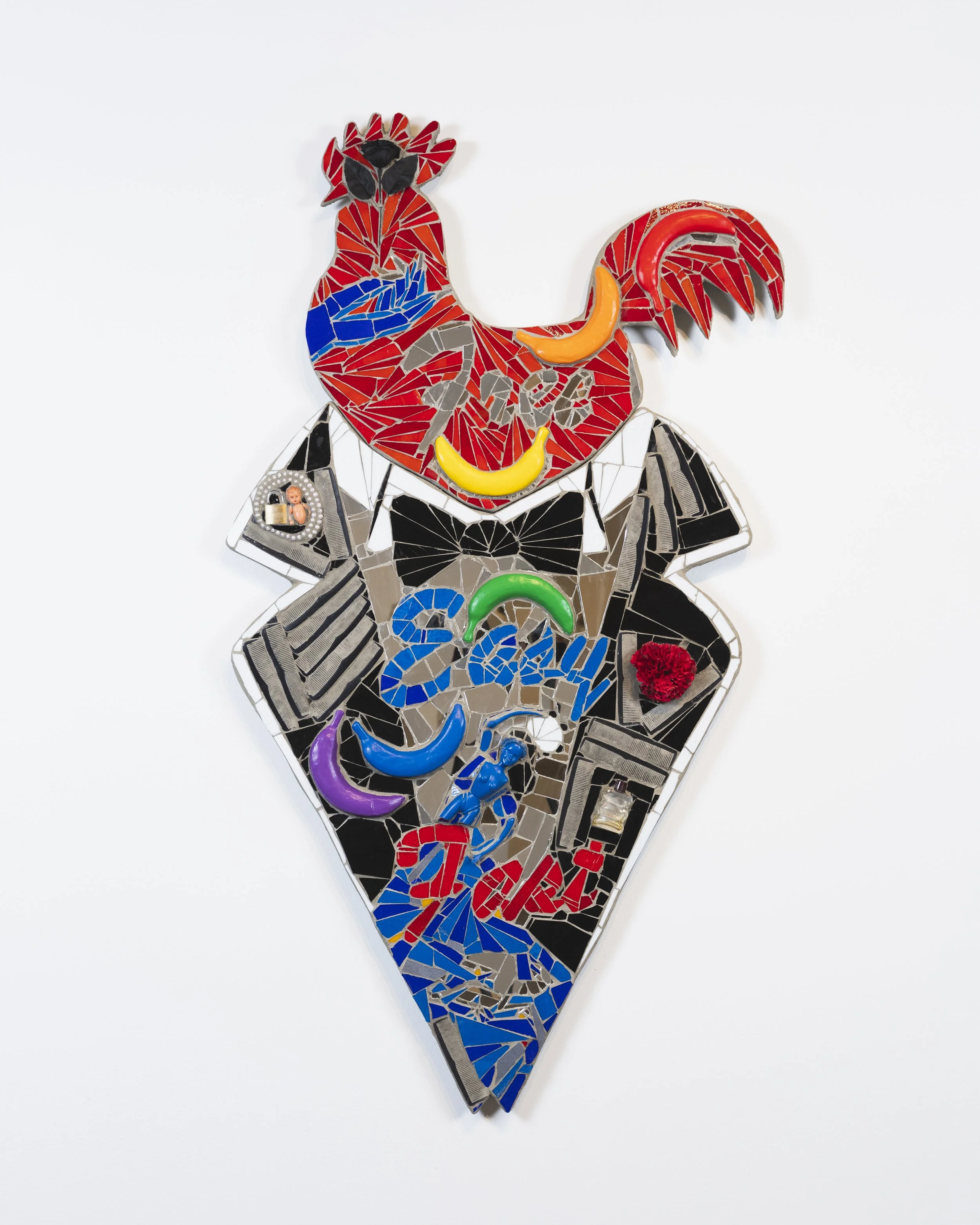 Marco DaSilva, "Free Easy Fast," 2025, Combs, perfume bottle, doll, plastic flowers, beaded necklace, gold plated bracelet, lock, foam bananas, house paint, mosaic glass, mirror and mortar on compressed foam board, 28 × 54 in.