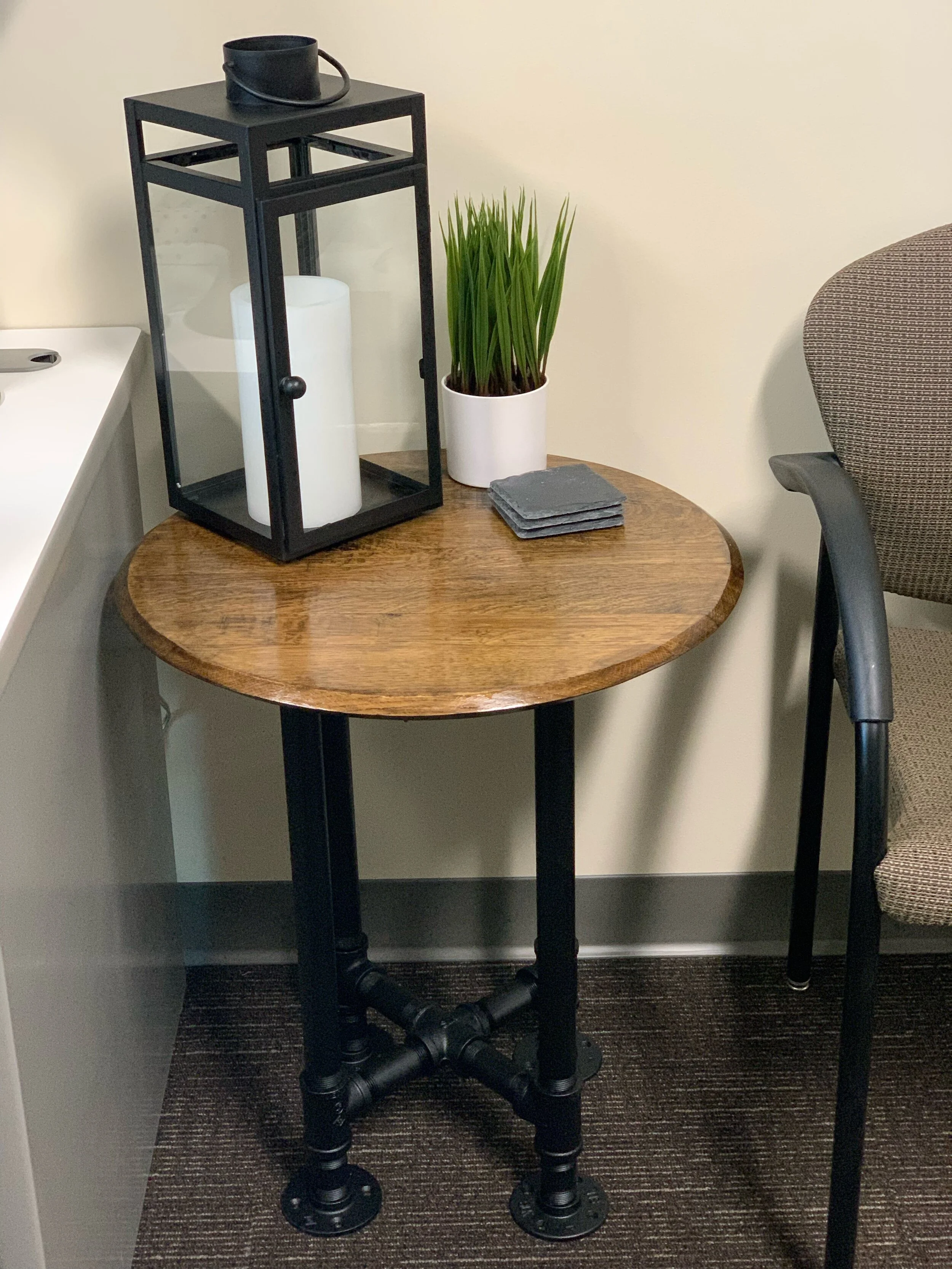Old World Company - Bourbon whiskey barrel head end table with black gas pipe legs. 