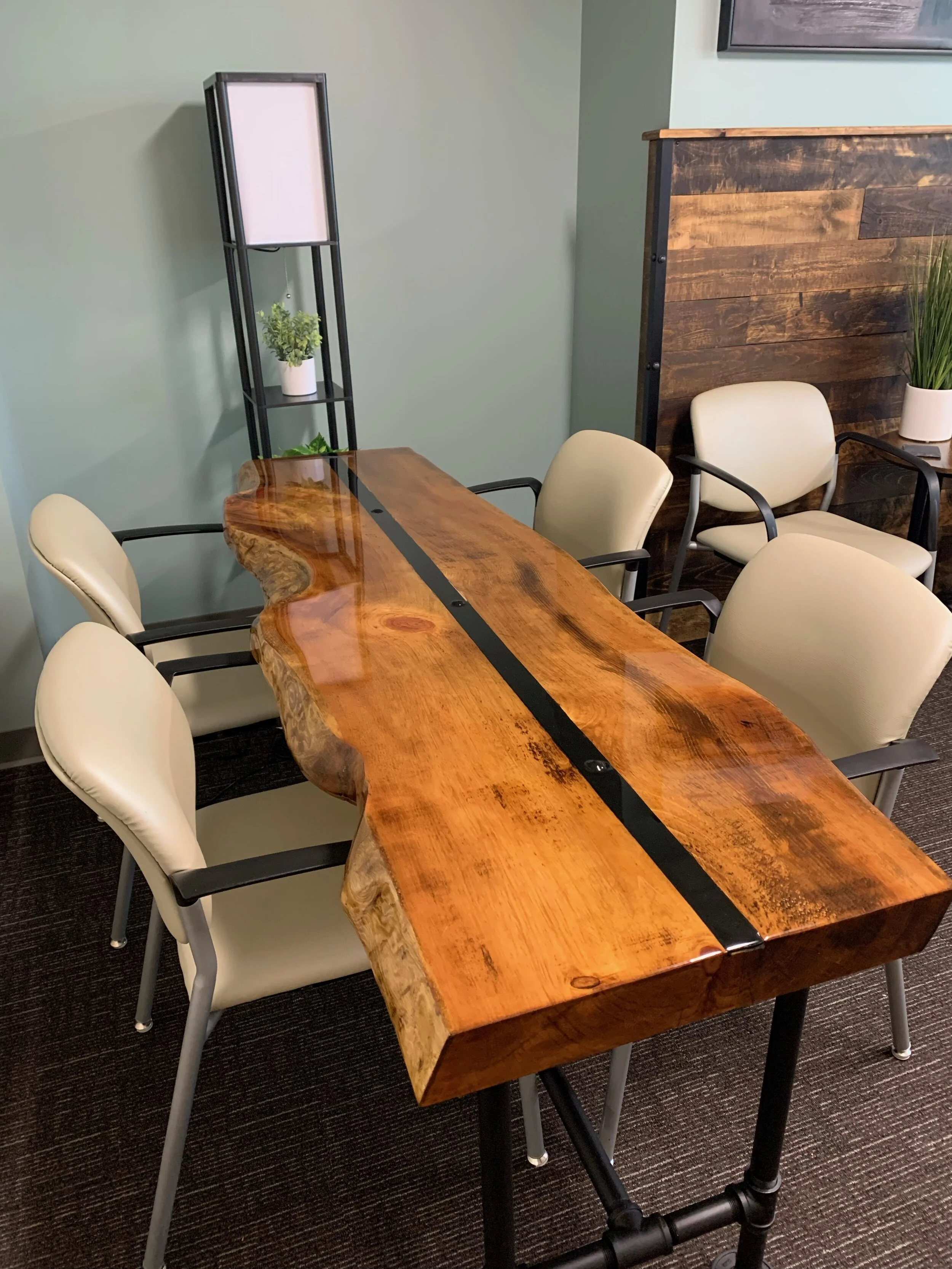 Old World Company - Conference table with epoxy flood coat and rustic metal strip. Black gas pipe legs.
