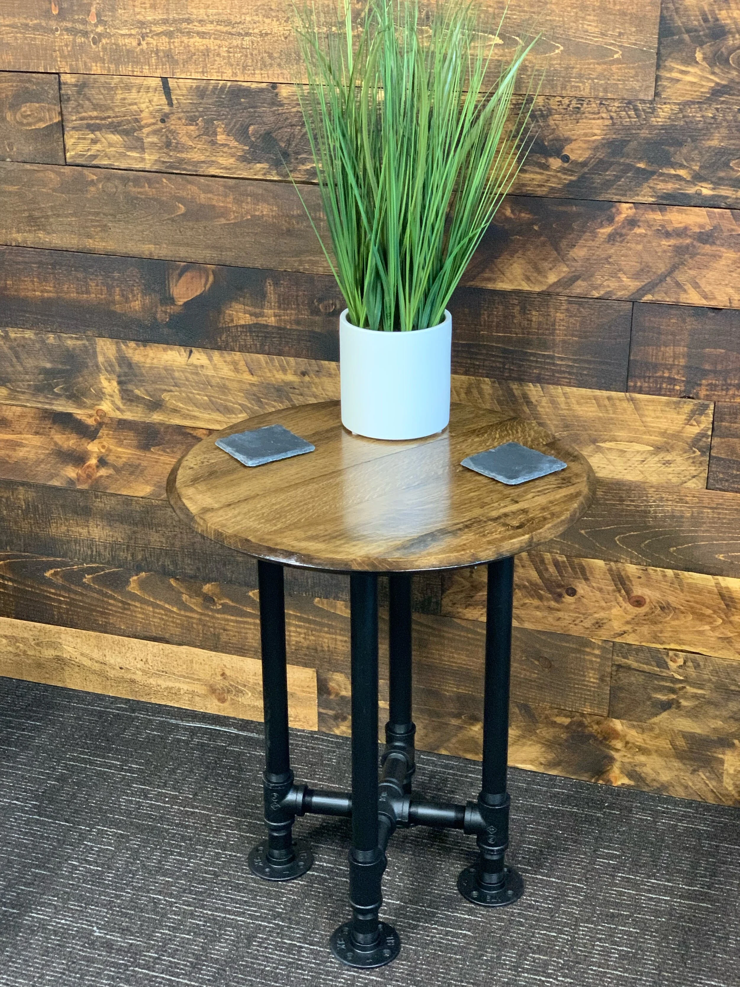 Old World Company - Bourbon whiskey barrel head end table with black gas pipe legs. 