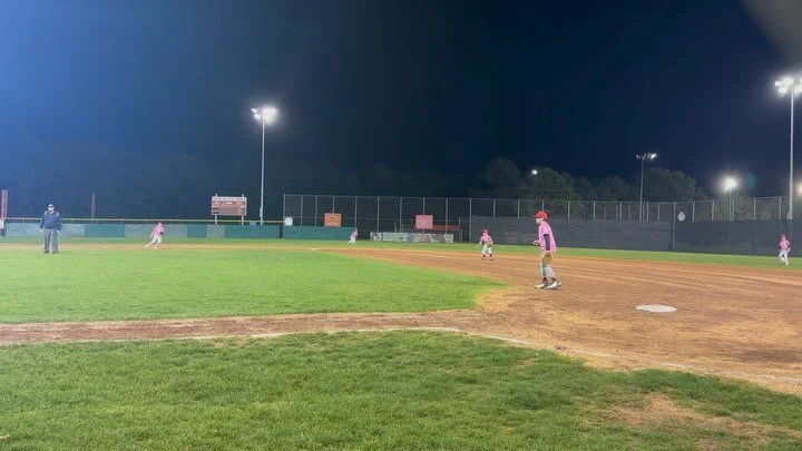 Night and day. Proudly wearing pink in support of breast cancer awareness month.💗⚾️
#baseballmom #familyfirst
.
.
.
ID 1: A little league team wearing pink shirts playing on a baseball field at night.

ID 2: A little league player wearing a pink shi