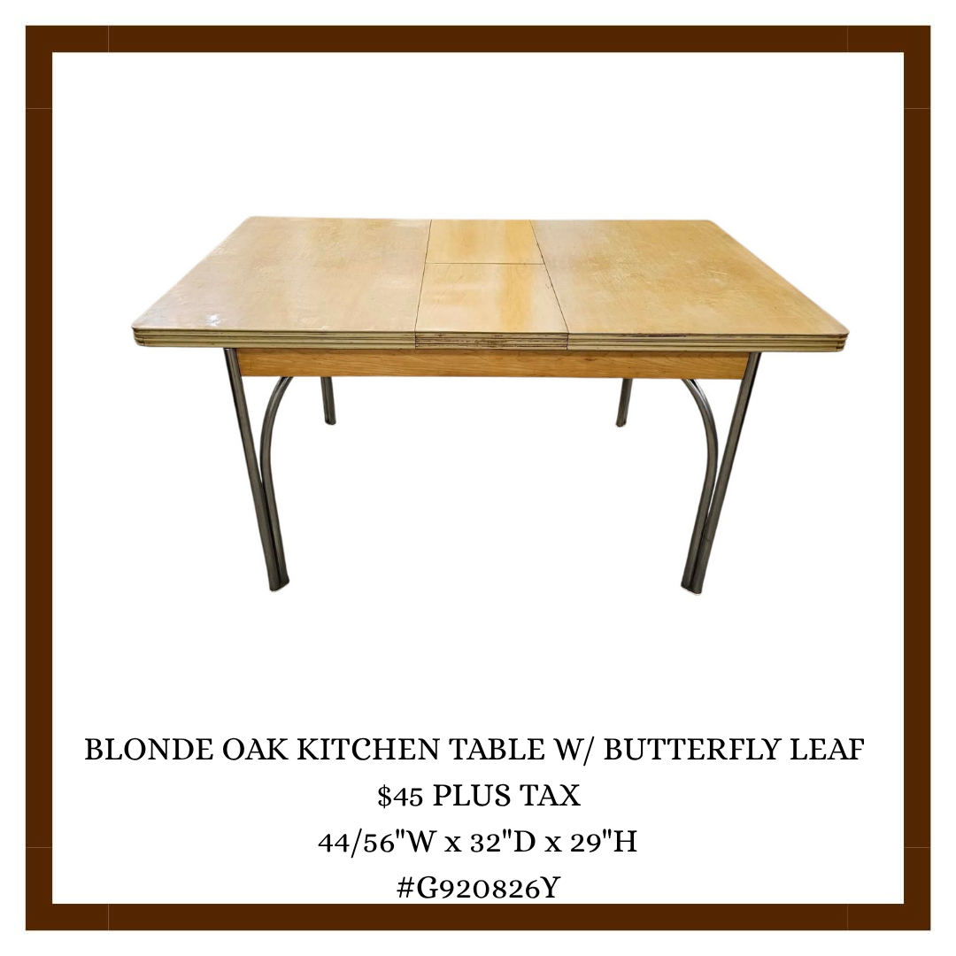A blonde oak kitchen table with butterfly leaf in a catalog advertisement.