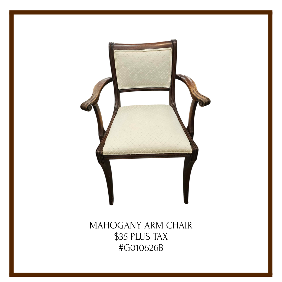 A wooden chair with cushioned, cream-colored upholstery and curved arms, displayed against a white background with a brown border and text describing it as a Mahogany Arm Chair priced at $35 plus tax.