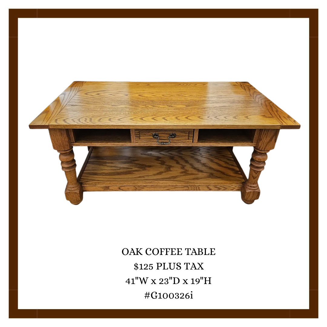 Wooden oak coffee table with a lower shelf and small open compartments and a drawer in the center, with a price and dimensions listed below.