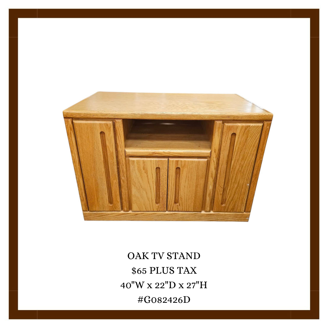 A wooden oak TV stand with two doors on either side and a central open shelf, vertical grooves in the doors.