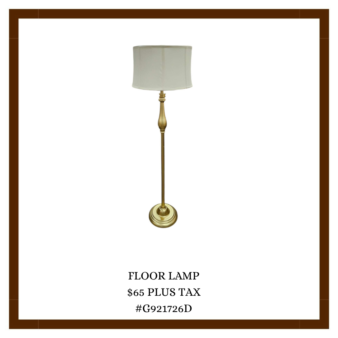 A tall floor lamp with a white lampshade and a brass stand, priced at $65 plus tax, with model number G921726D.