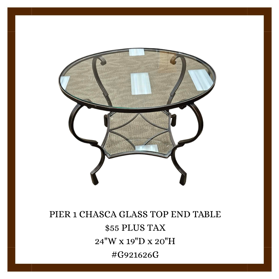 A round Pier 1 chasca glass top end table with a metal frame, glass surface, and patterned lower shelf, photographed against a plain white background.
