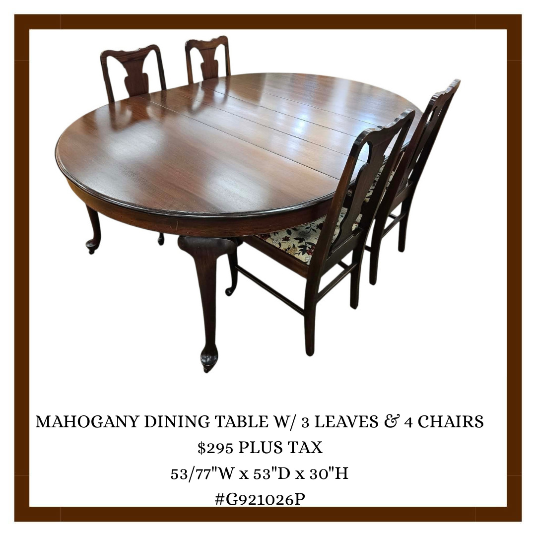 Wooden mahogany oval dining table with four matching chairs, detailed with a floral patterned cushion on one chair, showing a carved leg design.