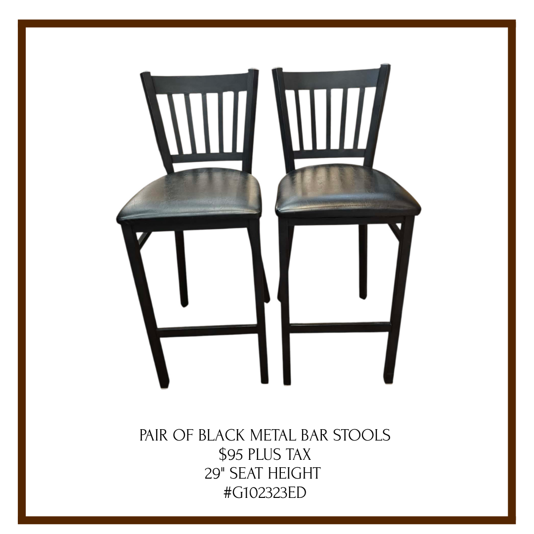 A pair of black metal bar stools with padded seats, listed with price and details.