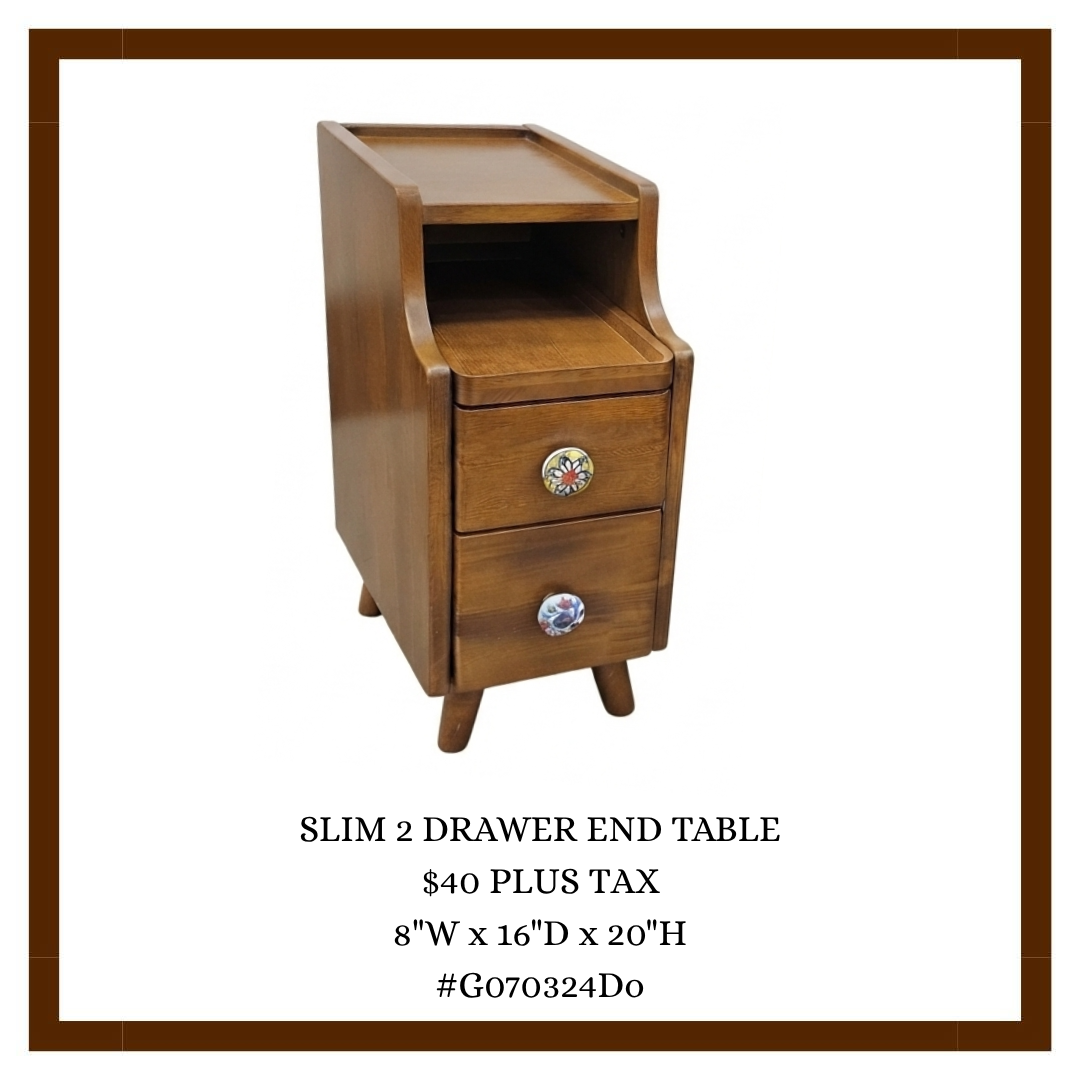 A vintage wooden end table with two drawers and decorative knobs, featuring a top surface and an open shelf below, standing against a white background.